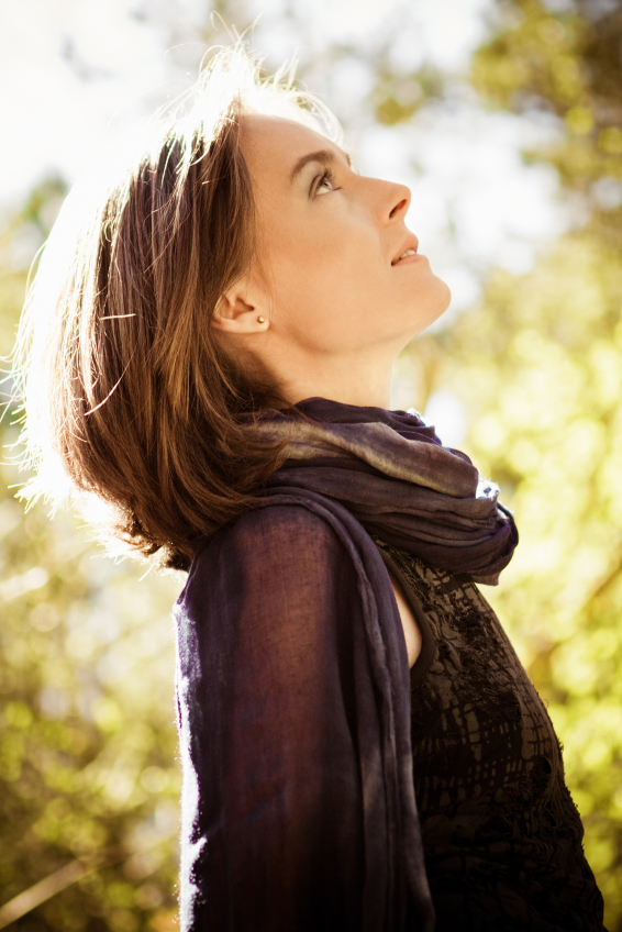 A woman looking up peacefully in the sunshine