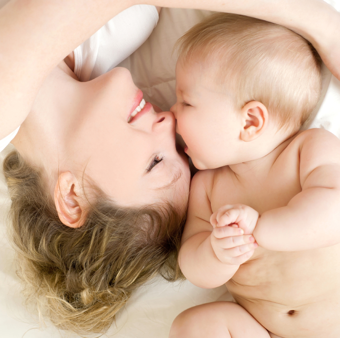 A mother lying nose-to-nose with her baby